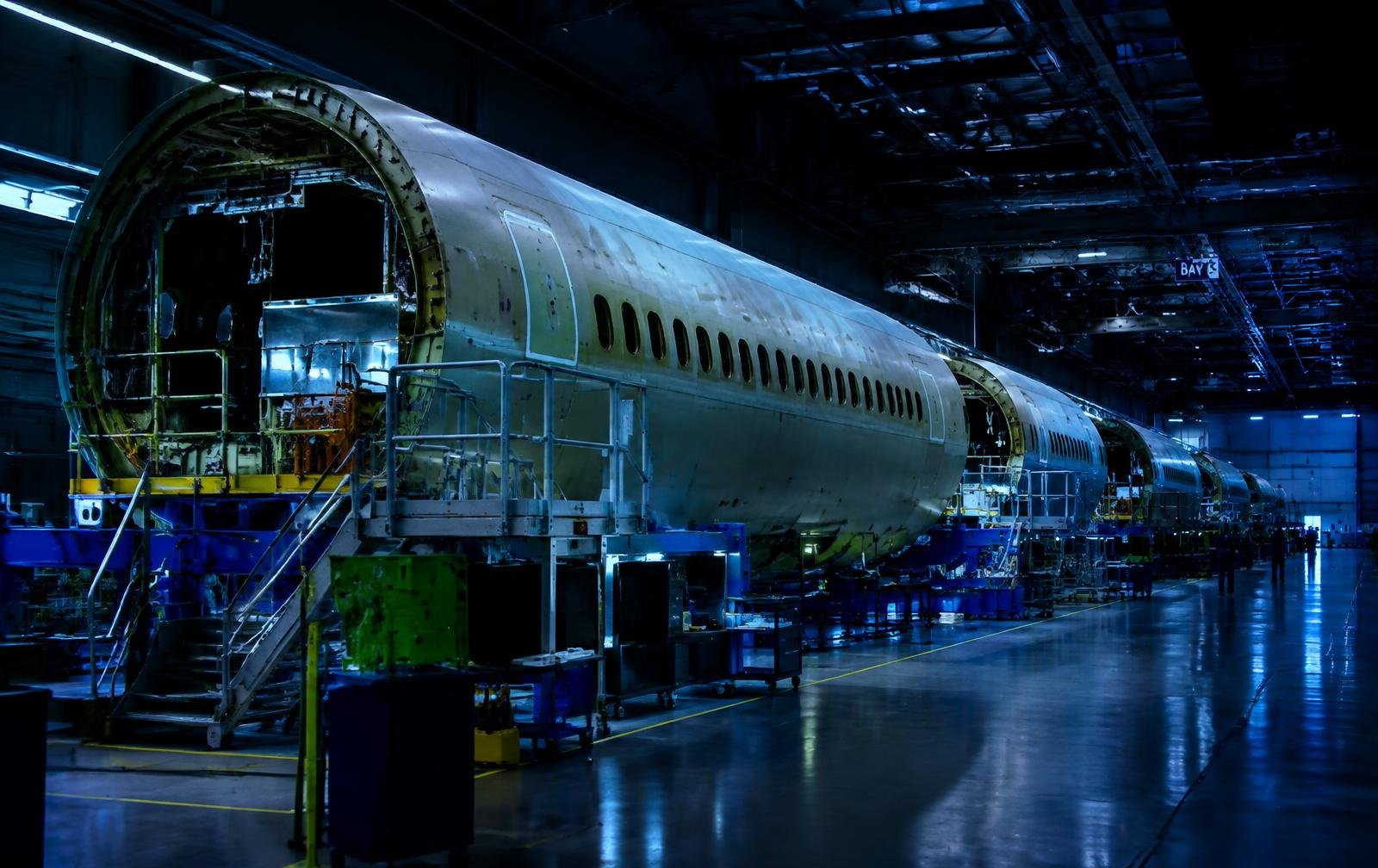 Technicians working on aircraft fuselage sections